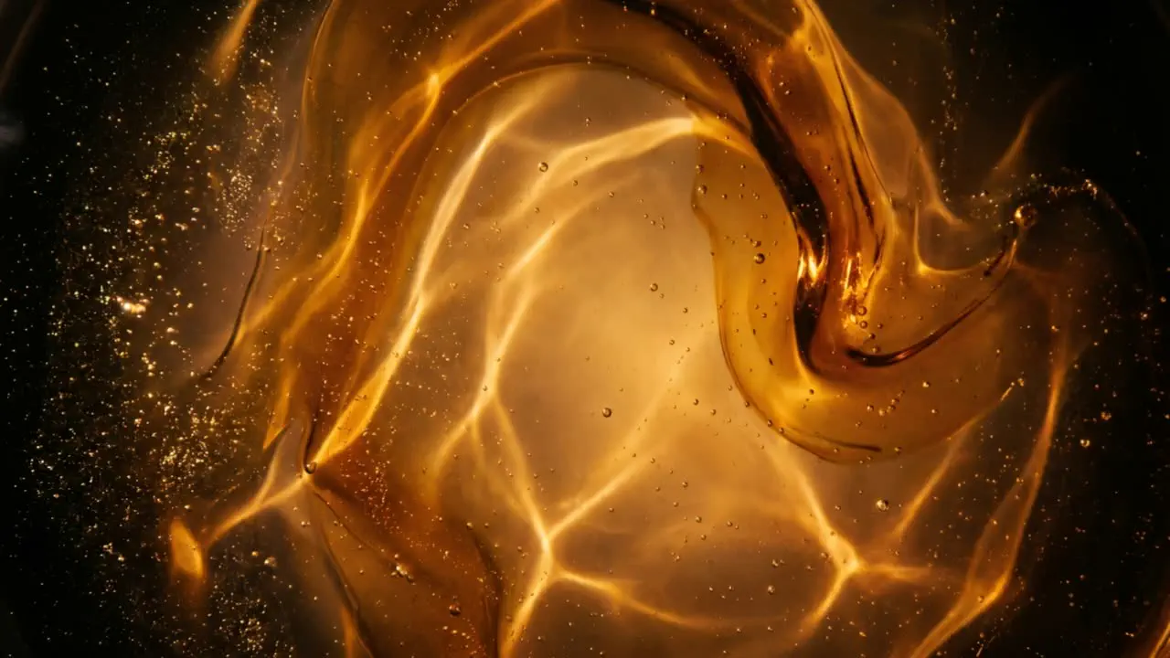 Aged oud resin swirling, molten amber lit from within.